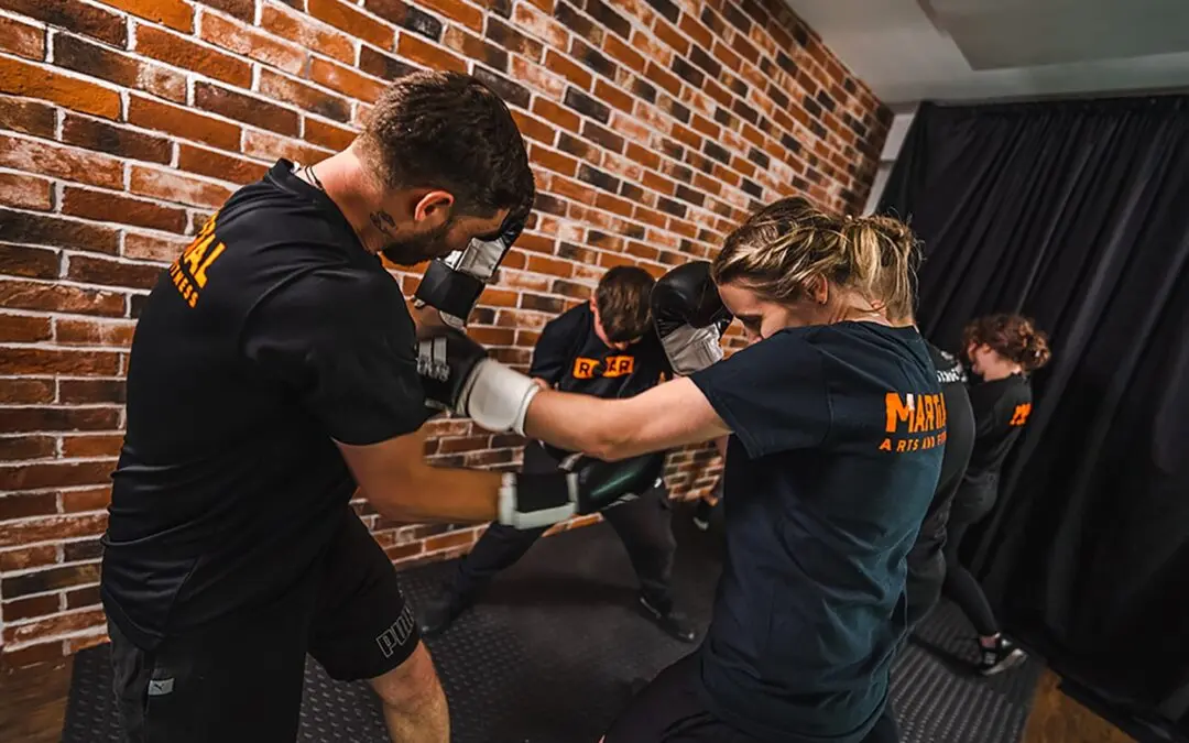 Members practice padwork drills together in group class at Roar Martial Arts